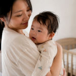 Mother picks up baby after a nap | Baby sweating | SafeSleep | Sleep monitoring devices